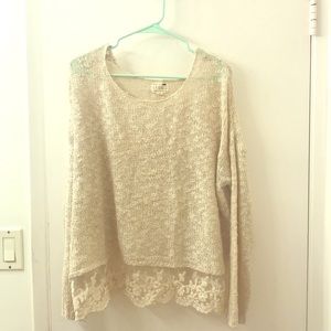 Lightweight sweater with lace detailing at bottom.